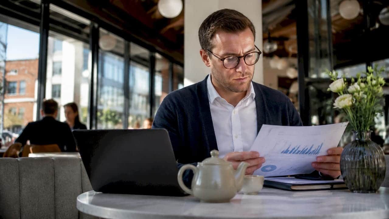 UK business owner reviewing Google Ads reports at kitchen table