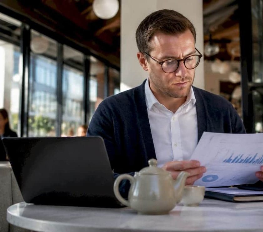 UK business owner reviewing Google Ads reports at kitchen table