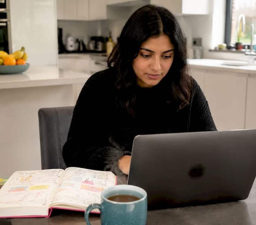 UK businesswoman setting up Google Ads on laptop at home